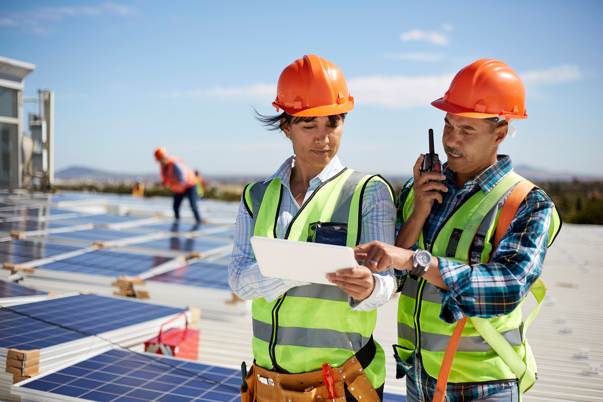 two individuals working on solar power