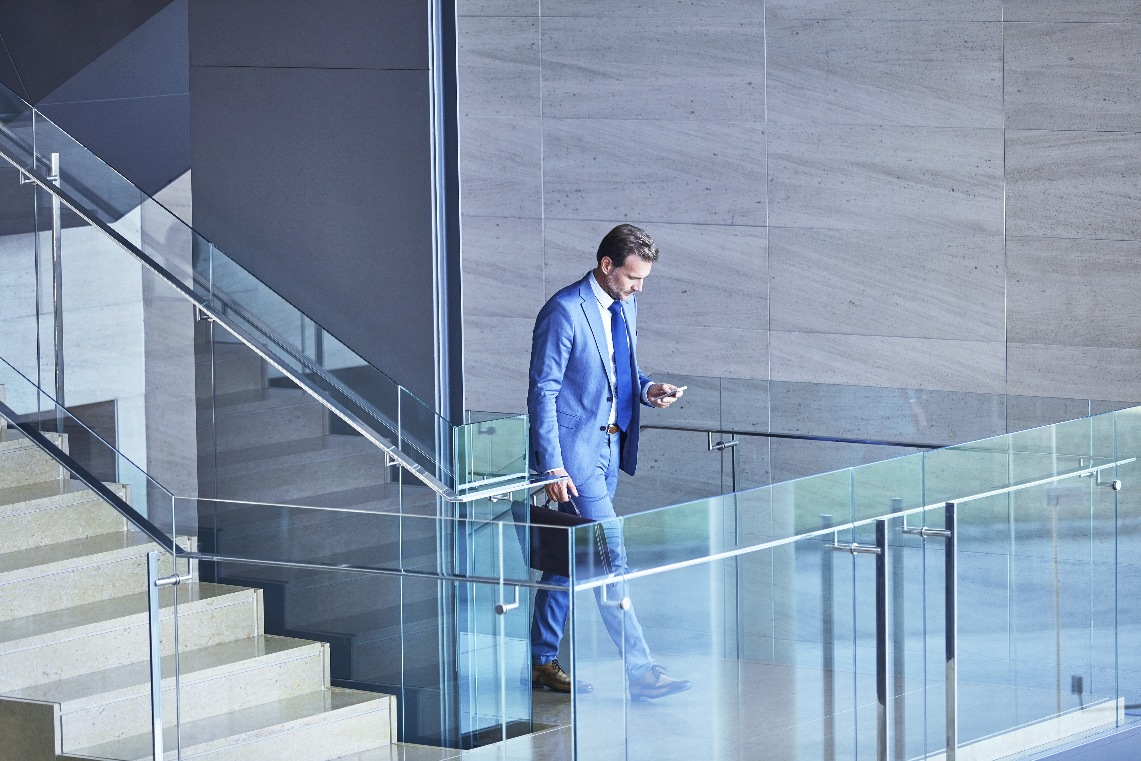 JW_man_blue_suit_walking_phone_RGB_150